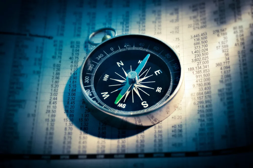 Compass lying on a page of printed data