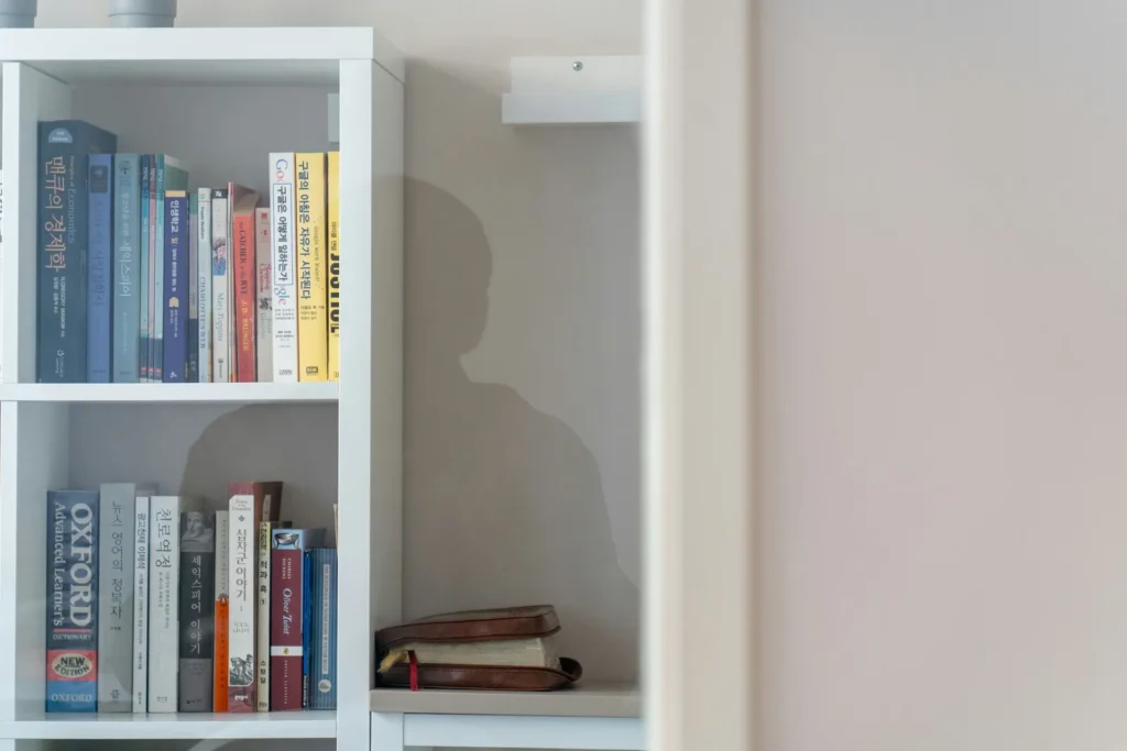 Half-empty bookshelf with gaps between books