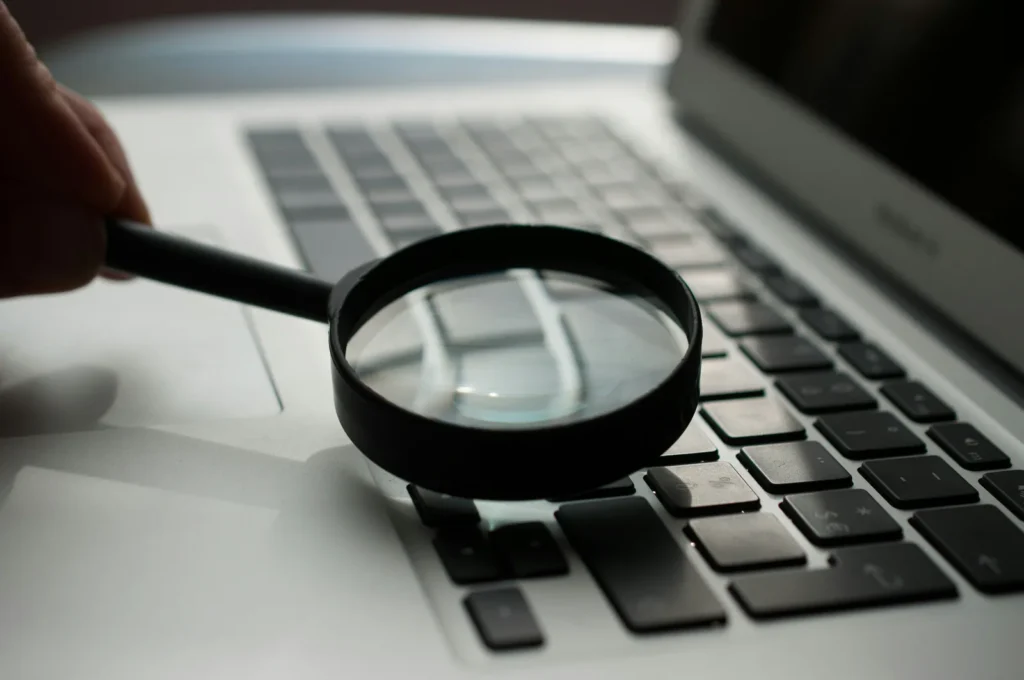 Magnifying glass over a laptop keyboard