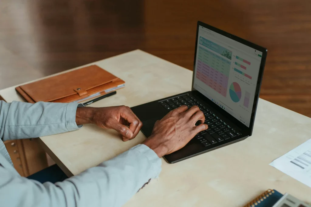Marketer analysing keyword data on a laptop