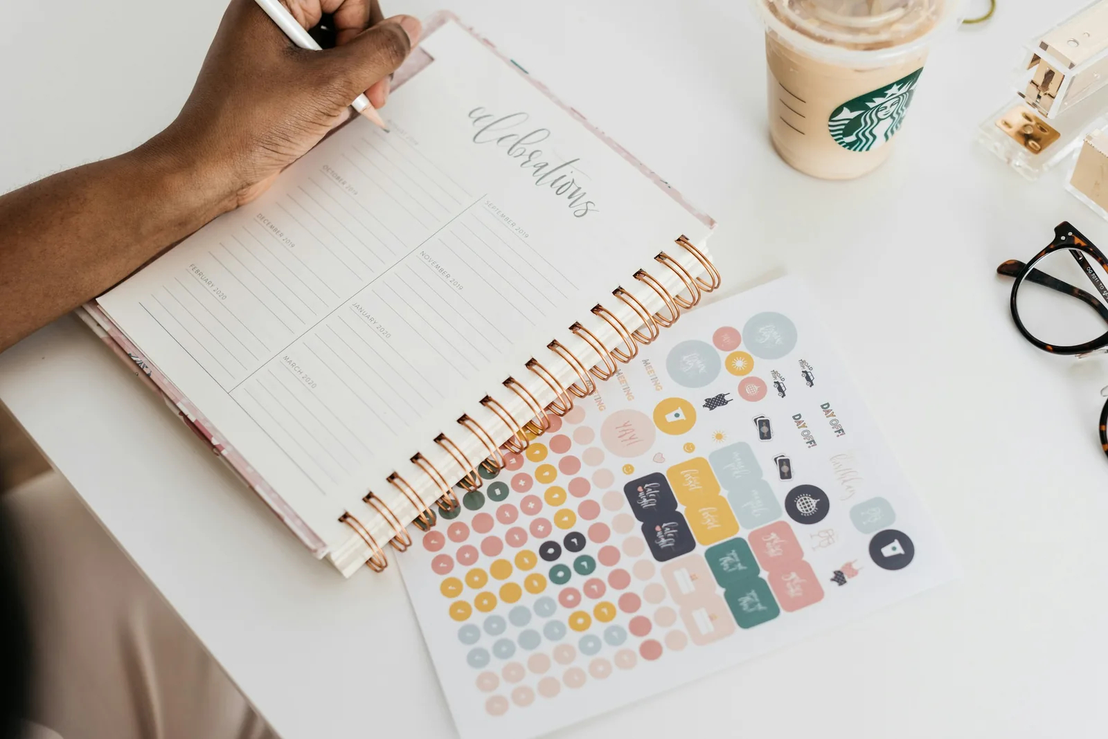 Person writing plans in a notebook