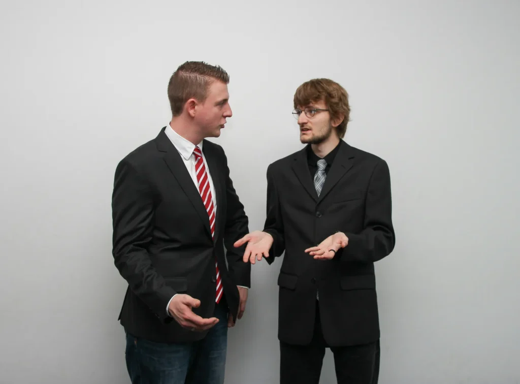 Two men in suits disagreeing with each other