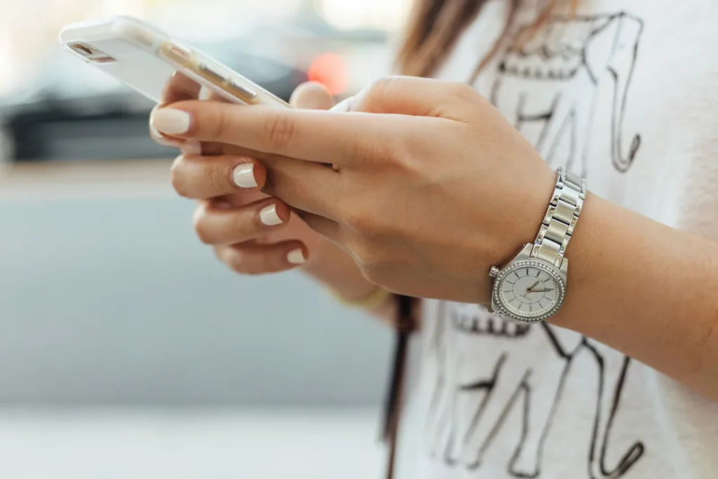 Person typing a search on a smartphone