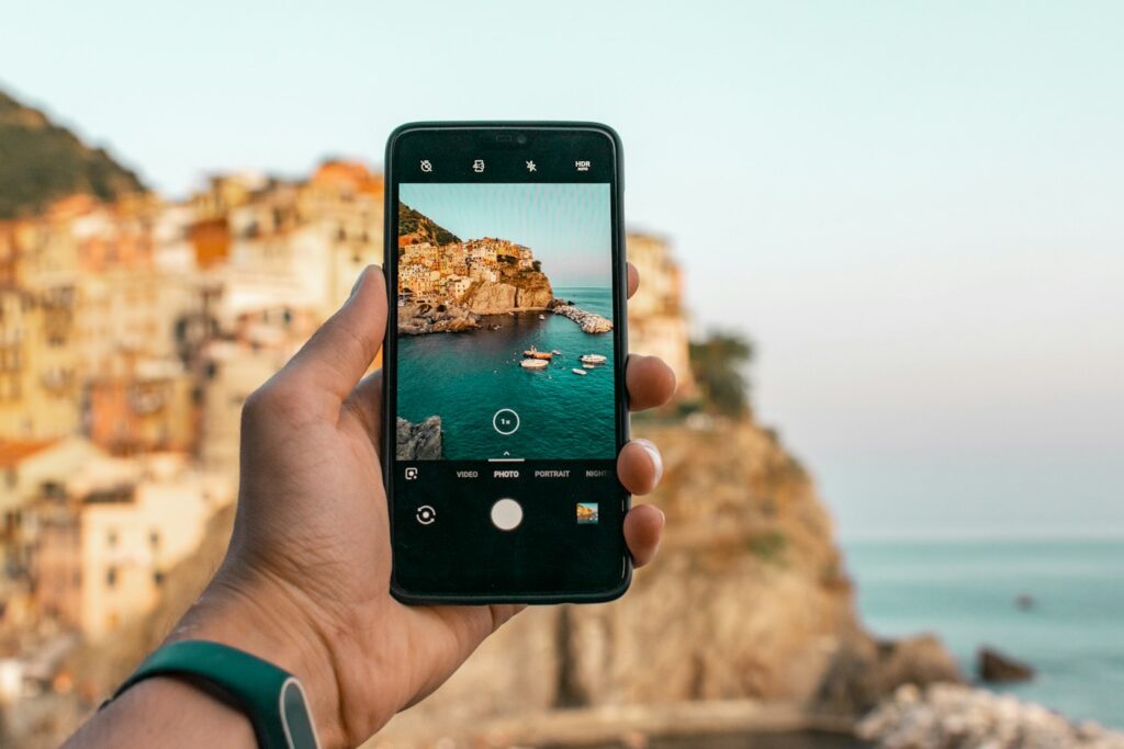 Person pointing a phone camera at an object